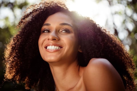 Cheerful woman with natural curly hair
