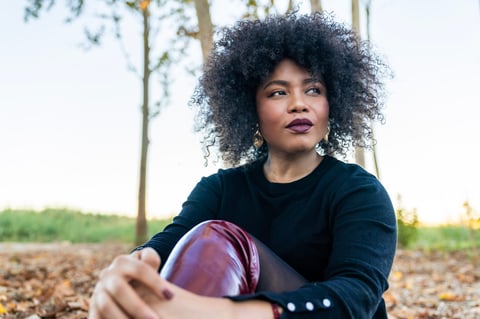Woman with afro hair in autumn